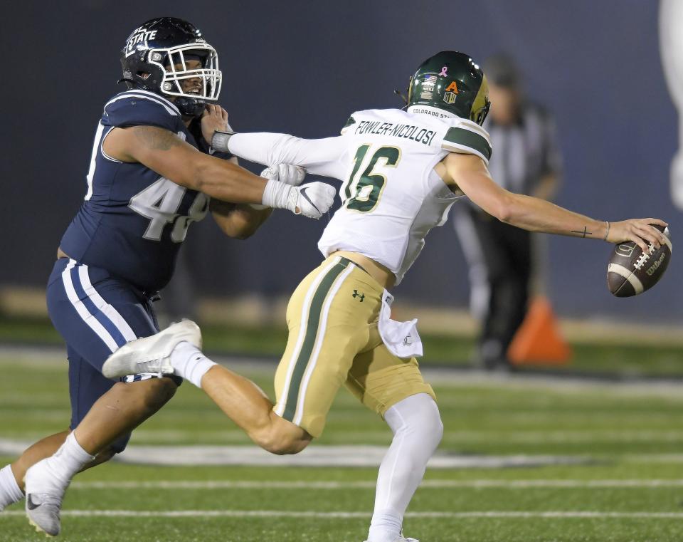 Utah State defensive tackle Seni Tuiaki (48) chases Colorado State quarterback Brayden Fowler-Nicolosi (16) during the second half of an NCAA college football game Saturday, Oct. 7, 2023, in Logan, Utah. | Eli Lucero/The Herald Journal via AP