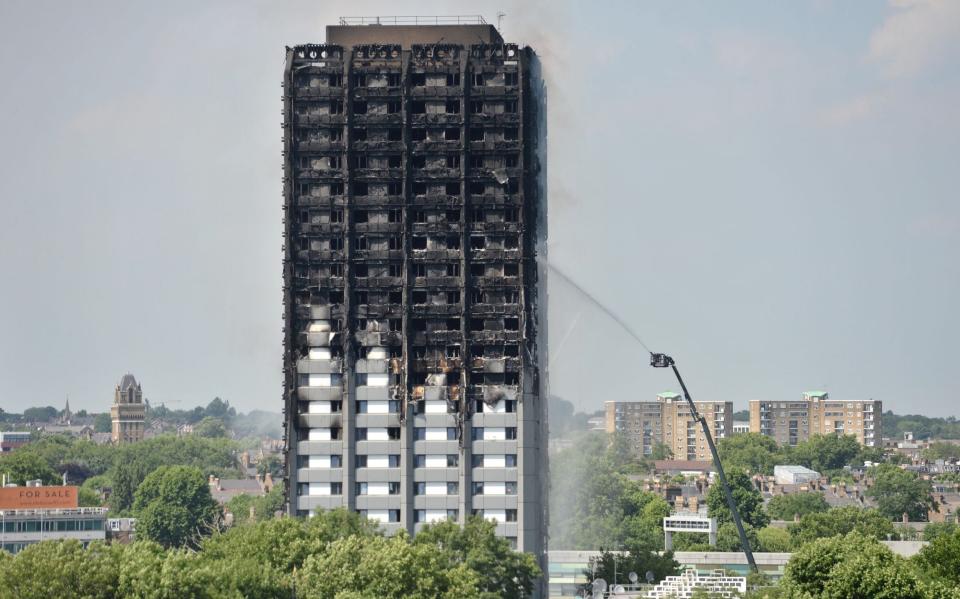 Firefighters spraying water after the fire engulfed Grenfell Tower in west London - Victoria Jones/PA