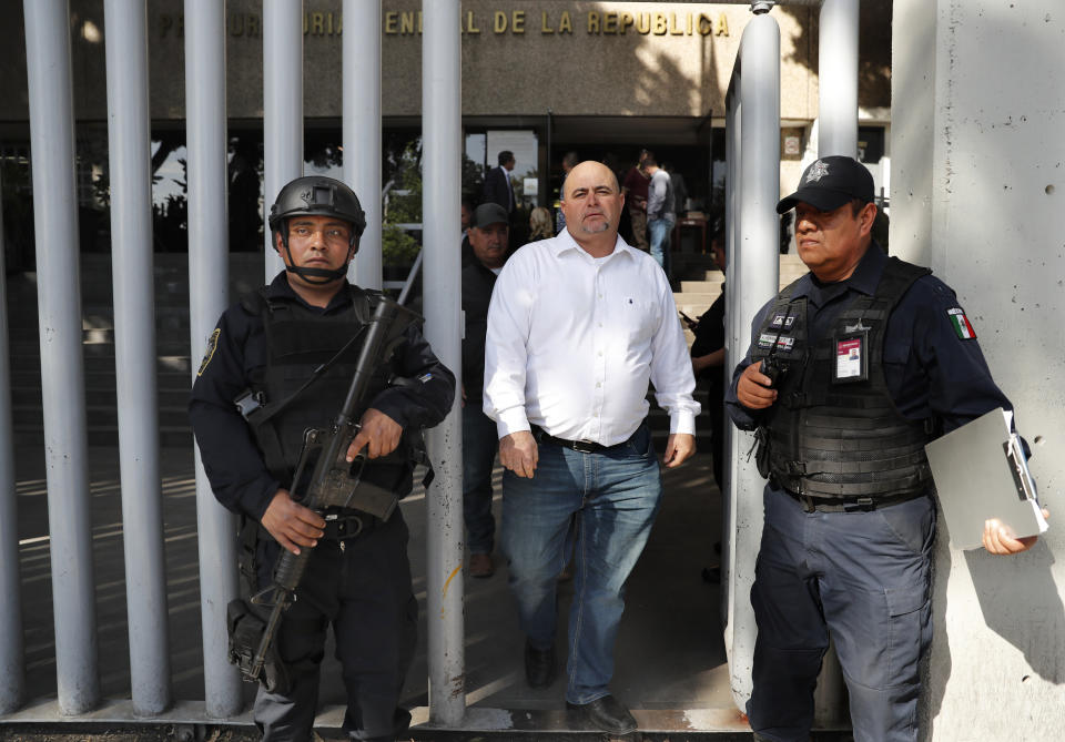 Julian LeBaron, center, who lost relatives and friends in a Nov. 4, 2019 ambush in northern Mexico, leaves the office of the Special Prosecutor for Organized Crime Investigation, where he met with authorities in Mexico City, Tuesday, Jan. 7, 2020. Prosecutors said Tuesday more than 40 suspects have been identified in connection with the slaughter of the nine U.S. dual-national women and children. (AP Photo/Marco Ugarte)