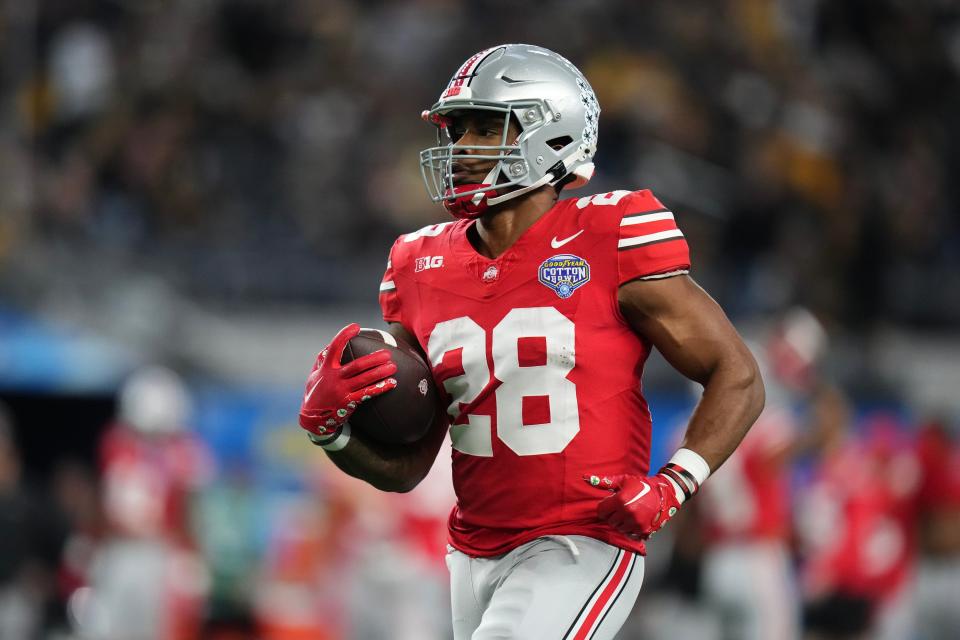 Dec 29, 2023; Arlington, Texas, USA; Ohio State Buckeyes running back TC Caffey (28) warms up prior to the Goodyear Cotton Bowl Classic against the Missouri Tigers at AT&T Stadium.