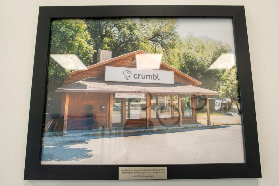 A photo of the first Crumbl Cookies location — which opened in Logan, Utah, in 2017 — hangs on the wall inside the new Topeka location.
