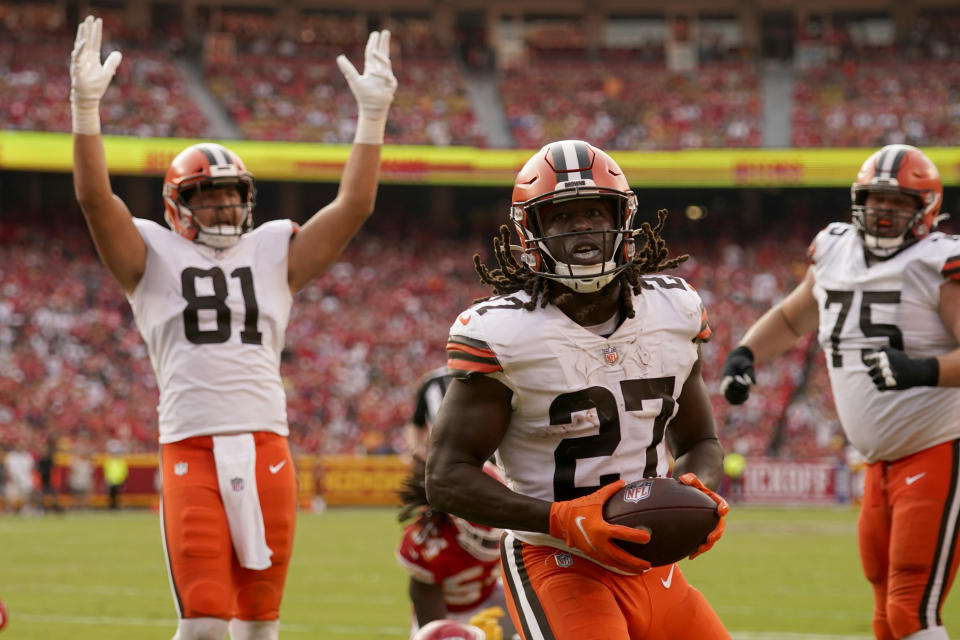 Cleveland Browns running back Kareem Hunt (27) scores as teammate Austin Hooper (81) celebrates during the second half of an NFL football game against the Kansas City Chiefs Sunday, Sept. 12, 2021, in Kansas City, Mo. (AP Photo/Charlie Riedel)