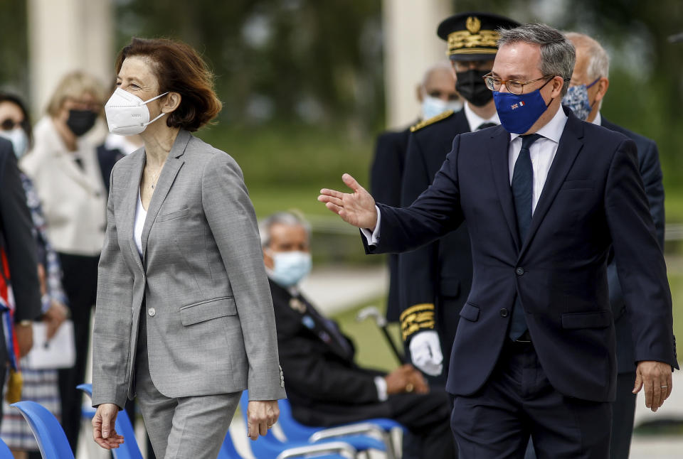 British ambassador to France, Edward Llewellyn, right, arrives with French Defense Minister Florence Parly for the inauguration of the British Normandy Memorial, in Ver-sur-Mer, France, Sunday, June 6, 2021. The monument, built under a project launched in 2016, pays tribute to those under British command who died on D-Day and during the Battle of Normandy. The names of more than 22,000 men and women, mostly British soldiers, are written on its stone columns. (Sameer Al-Doumy/Pool via AP)