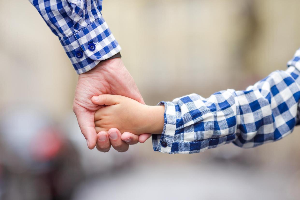 Dad holding daughter's hand