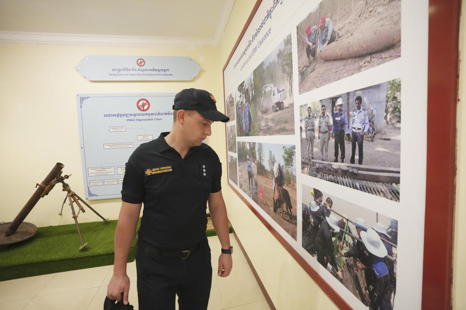 A Ukrainian deminer views an exhibition during a tour of the Peace Museum Mine Action in Siem Reap province, northwestern Cambodia, Friday, Jan. 20, 2023. Cambodian experts, whose country has the dubious distinction of being one of the world's most contaminated by landmines, walked a group of Ukrainian soldiers through a minefield being actively cleared hoping their decades of experience will help the Europeans in their own efforts to remove Russian mines at home. (AP Photo/Heng Sinith)