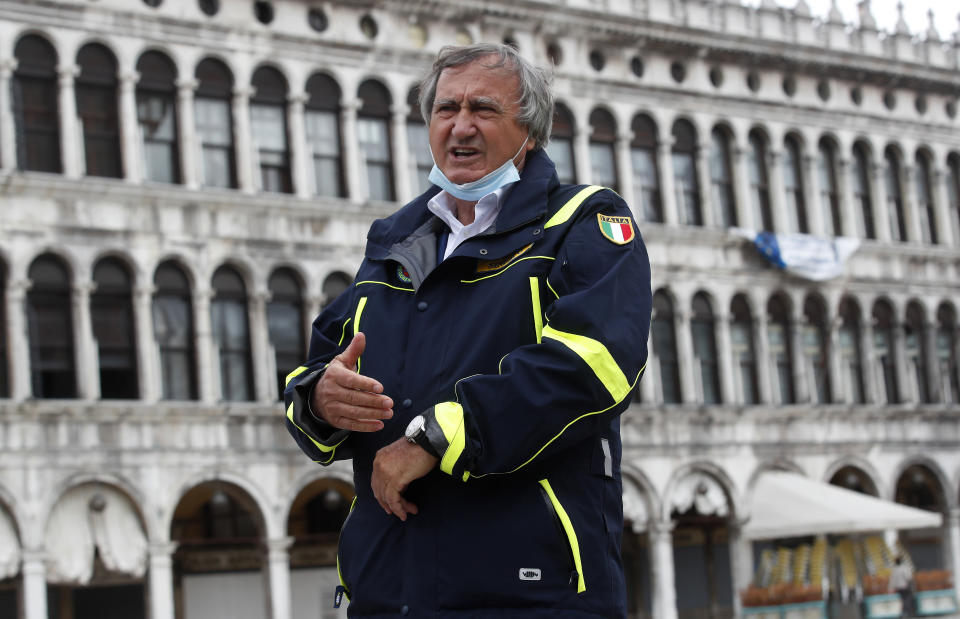 In this picture taken on Wednesday, May 13, 2020, Venice's Mayor Luigi Brugnaro talks with The Associated Press in St. Mark's Square in Venice, Italy. Venetians are rethinking their city in the quiet brought by the coronavirus pandemic. For years, the unbridled success of Venice's tourism industry threatened to ruin the things that made it an attractive destination to begin with. Now the pandemic has ground to a halt Italy’s most-visited city, stopped the flow of 3 billion euros in annual tourism-related revenue and devastated the city's economy. (AP Photo/Antonio Calanni)