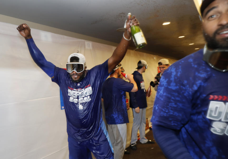 The Los Angeles Dodgers' Yasiel Puig celebrates clinching a playoff spot after beating the San Francisco Giants in a baseball game in San Francisco, Saturday, Sept. 29, 2018. (AP Photo/Jim Gensheimer)