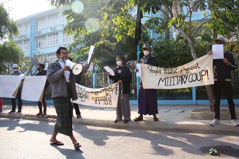 People protest on the street against the military after Monday's coup, outside the Mandalay Medical University in Mandalay