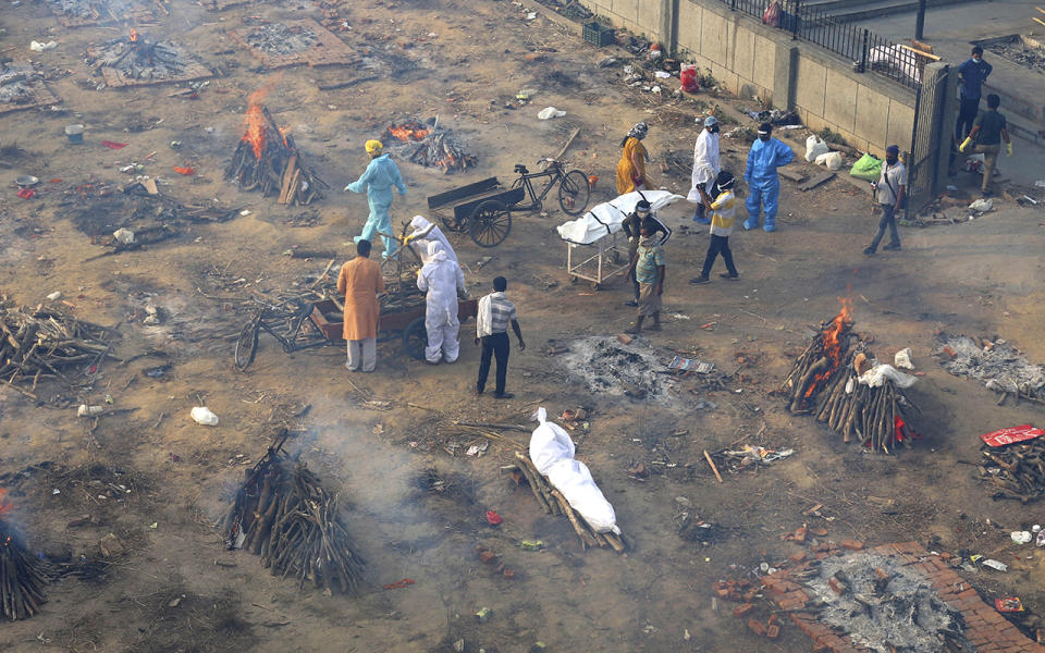 A series of funeral pyres near a funeral home.