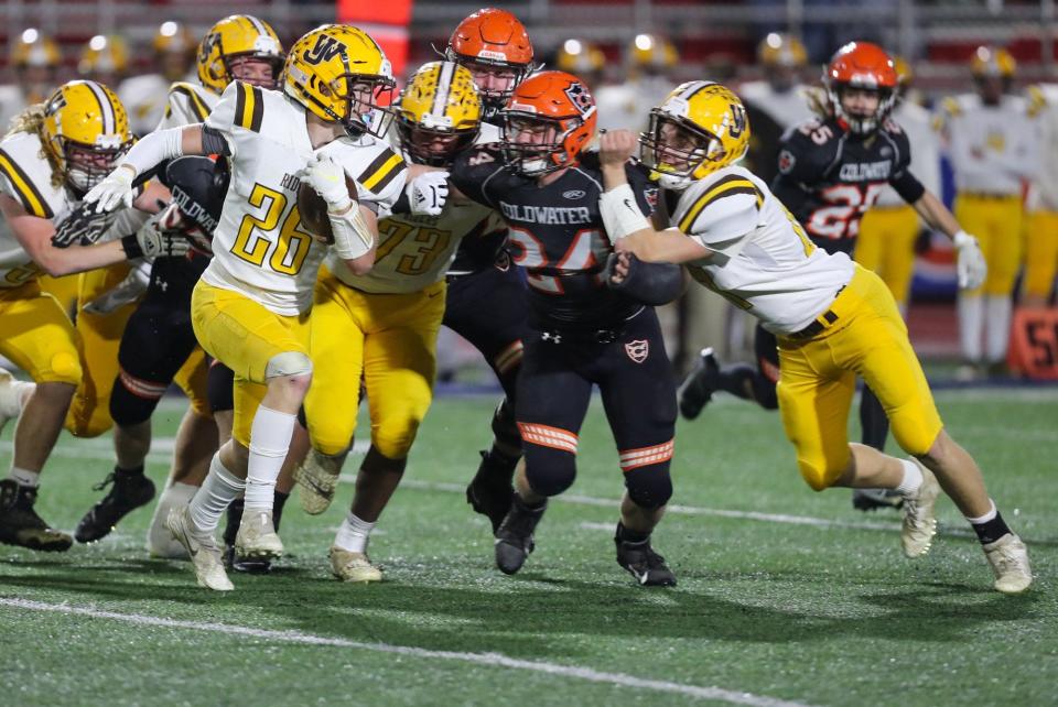 Coldwater defender Darin Schmitmeyer (24) is double-teamed by West Jefferson blockers as he closes in on Hayden Salyer (26) during a Division VI state semifinal Nov. 27 at Piqua. West Jefferson lost 35-13.