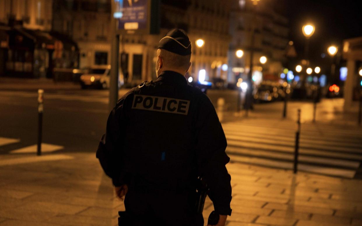 A police officer patrols in Paris - AFP