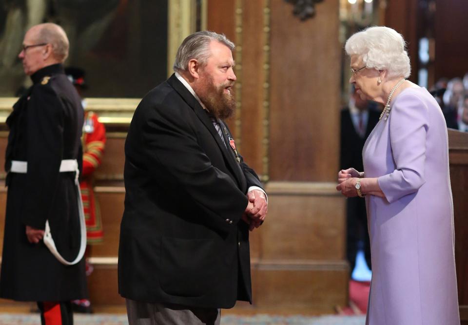 Actor Brian Blessed is made an Officer of the Order of the British Empire (OBE) by Queen Elizabeth II during an Investiture ceremony at Windsor Castle.