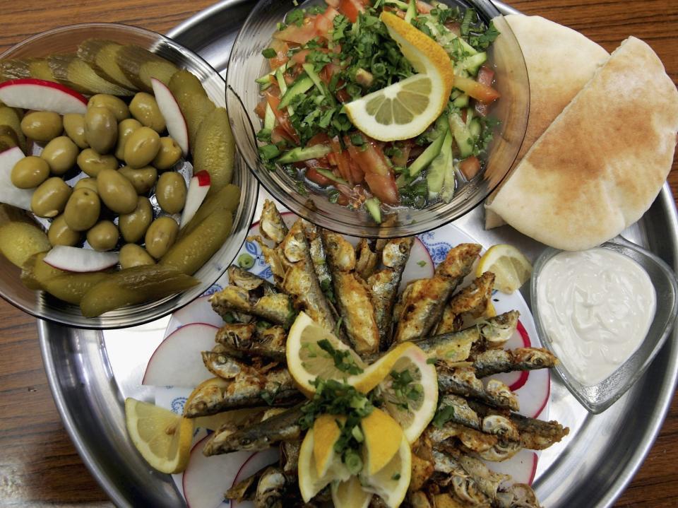 bowls of mediterranean-inspired food on a big platter