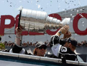 LOS ANGELES, CA - JUNE 14: Los Angeles Kings team members Anze Kopitar #11 and Dustin Brown #23 hold the Stanley Cup to cheering fans during the Stanley Cup victory parade on June 14, 2012 in Los Angeles, California. The Kings are celebrating their first NHL Championship in the team's 45-year-old franchise history. (Photo by Kevork Djansezian/Getty Images)