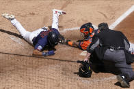 Minnesota Twins' Luis Arraez, left, is tagged out by Houston Astros catcher Martin Maldonado as he attempted to score on a Marwin Gonzalez single in the fifth inning of Game 2 of an American League wild-card baseball series, Wednesday, Sept. 30, 2020, in Minneapolis. Home plate umpire Manny Gonzalez watches to make the call. (AP Photo/Jim Mone)