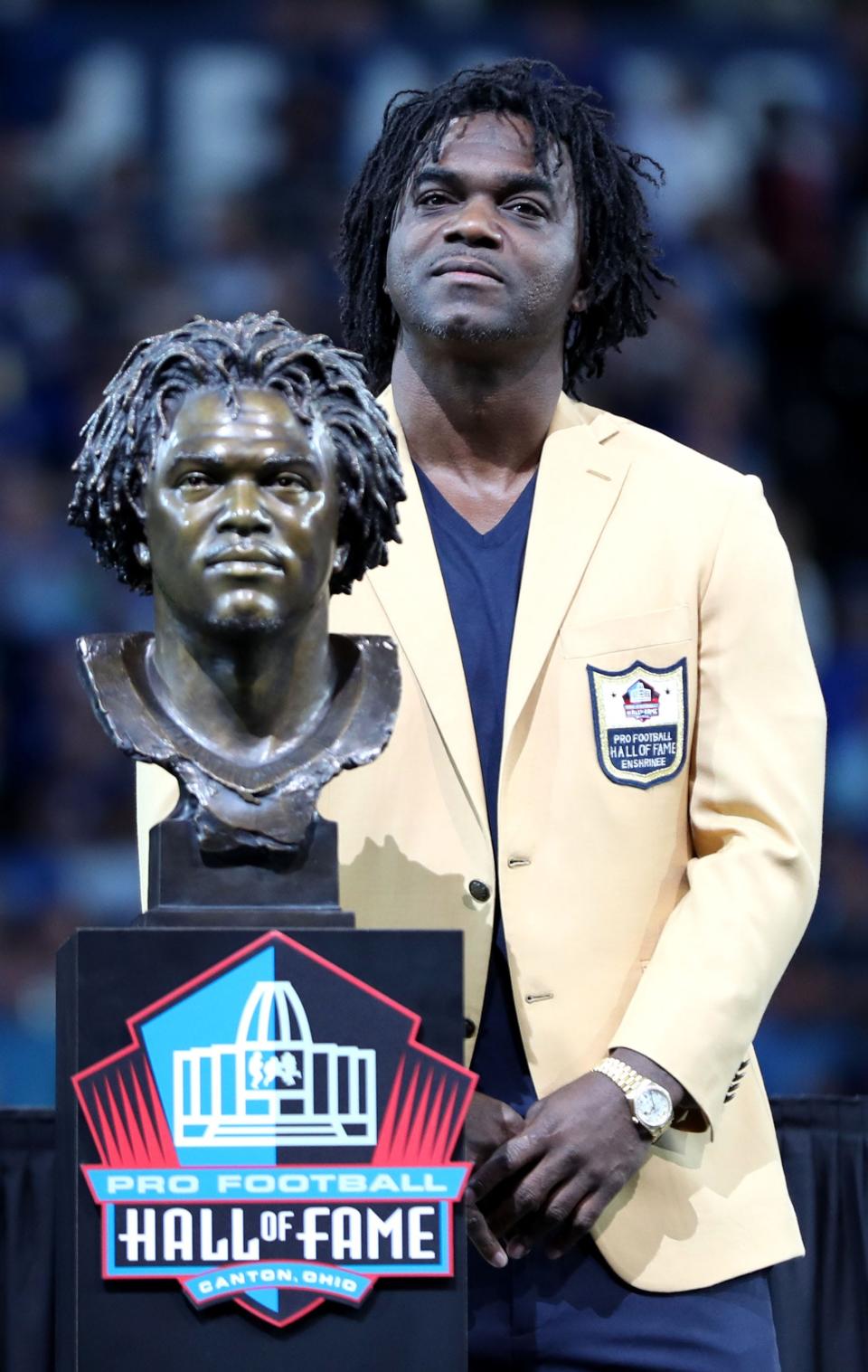 Edgerrin James stands next to his bust after receiving his hall of fame ring Sunday, Sept. 19, 2021, during halftime of a game against the Los Angeles Rams at Lucas Oil Stadium in Indianapolis.