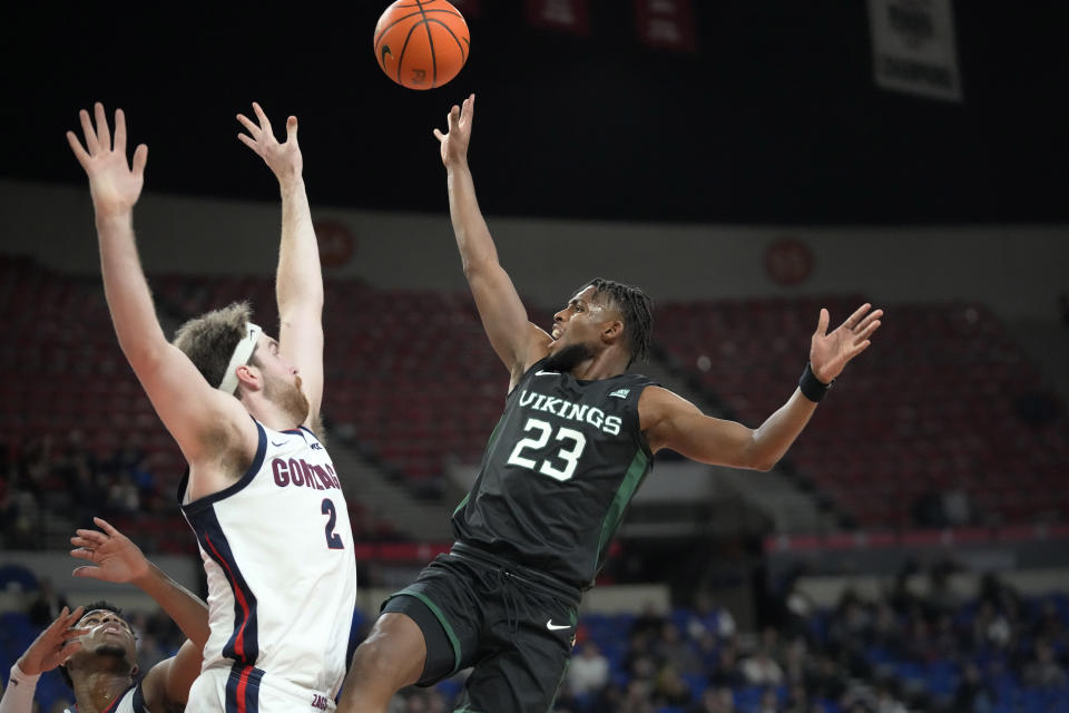 Portland State guard Jorell Saterfield (23) shoots as Gonzaga forward Drew Timme (2) defends during the first half of an NCAA college basketball game in the Phil Knight Legacy tournament Thursday, Nov. 24, 2022, in Portland, Ore. (AP Photo/Rick Bowmer)