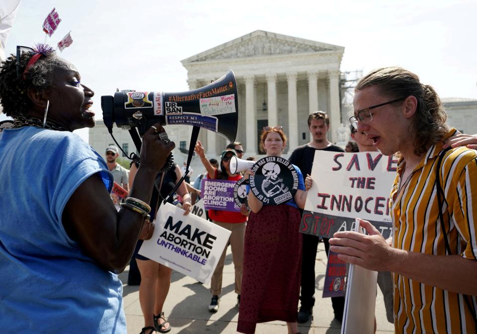 FILE PHOTO: An anti-abortion protester and pro-abortion protester demonstrate outside the U.S. Supreme Court on the day when decisions are expected to be handed down, in Washington, U.S., June 26, 2024. REUTERS/Kevin Lamarque/File Photo