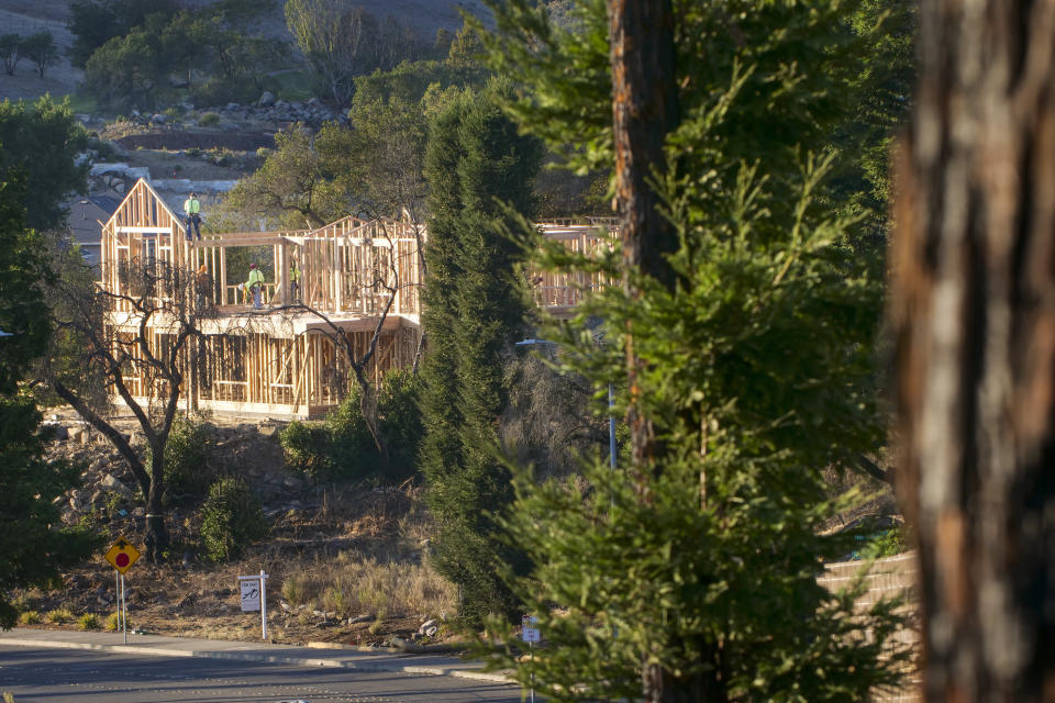 In this Tuesday, Nov. 5, 2019, photo, builders work on a new home in Santa Rosa, Calif. Many homes in the city were destroyed during the Tubbs Fire of 2017, and many of those homes are still being replaced and rebuilt. This Fountaingrove section of Santa Rosa in California's wine country was one of the neighborhoods turned to piles of ash and debris by the now infamous Tubbs Fire of 2017. It had been the most destructive wildfire in California history, until last year, when the Camp Fire ravaged the town of Paradise, to the north, killing 86 people. (AP Photo/Lacy Atkins)