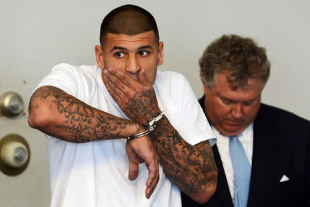FILE PHOTO - New England Patriots tight end Aaron Hernandez is arraigned on charges of murder and weapons violations in Attleborough, Massachusetts, U.S. on June 26, 2013. REUTERS/Mike George/Pool/File Photo