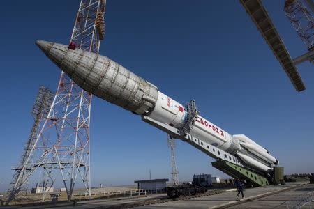 The Proton rocket, that will launch the ExoMars 2016 spacecraft to Mars, is lifted on the launchpad at the Baikonur cosmodrome, Kazakhstan, in this handout photo released by European Space Agency (ESA) on March 11, 2016. REUTERS/Stephane Corvaja/ESA/Handout via Reuters