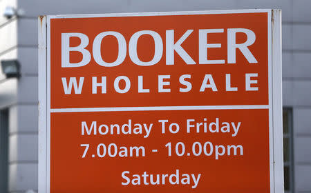 FILE PHOTO: A branded sign is displayed outside of a Booker Wholesale store in London, Britain January 27, 2017. REUTERS/Neil Hall /File Photo