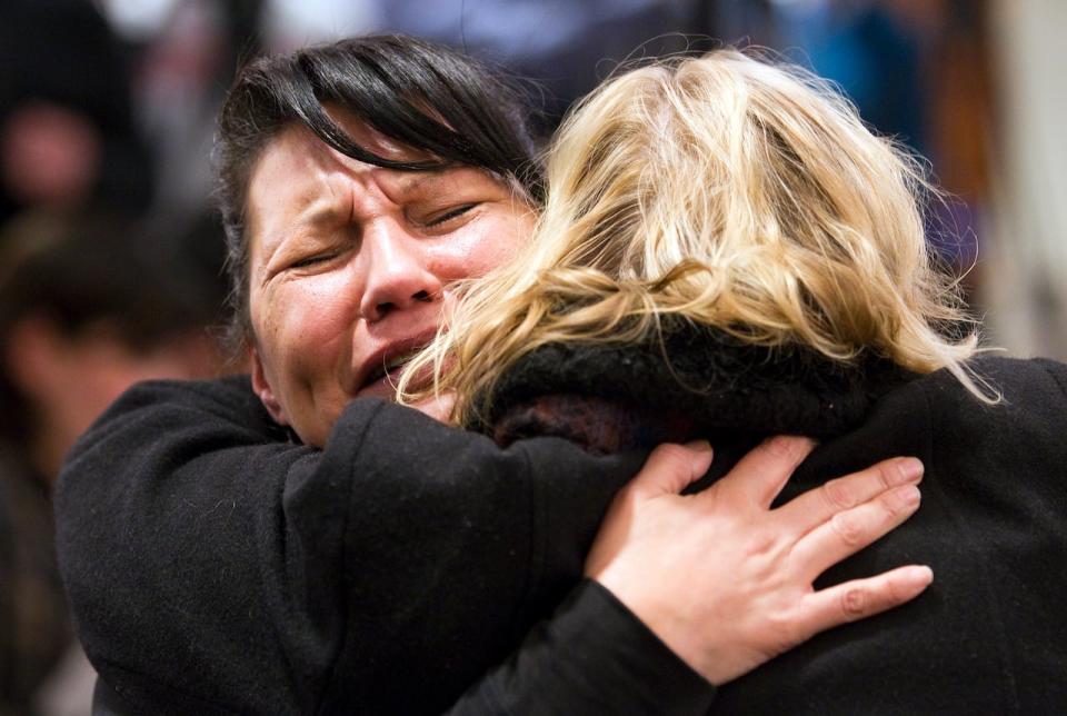 Former sex trade worker CeeJay Julian (L) breaks down during Wally Oppal's remarks shortly after the Missing Women's Commission of Inquiry was made public in Vancouver, British Columbia December 17, 2012. The 1,448-page report examines the mishandling of the Robert Pickton serial killer case by the Vancouver Police Department (VPD).  REUTERS/Ben Nelms  (CANADA - Tags: CRIME LAW) - RTR3BOZ9