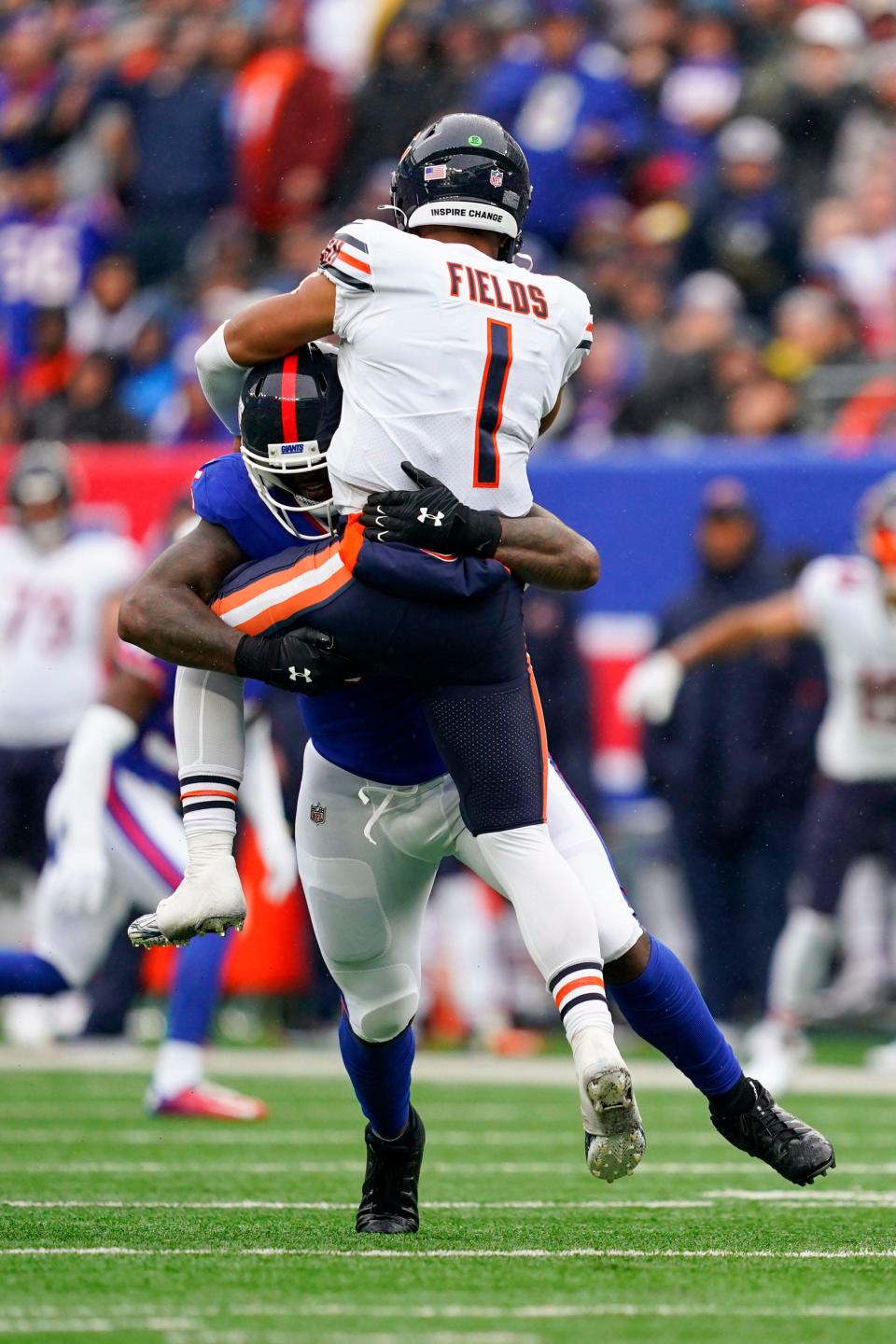 New York Giants linebacker Jihad Ward (55) hits Chicago Bears quarterback Justin Fields (1) as Fields throws the ball in the second half.  The Giants defeated the Bears, 20-12, at MetLife Stadium on Sunday, Oct.  2, 2022, in East Rutherford.