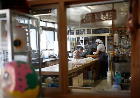 Family members of Shigeyuki Kaneta make sweets at their confectionery shop in Nanmoku Village, northwest of Tokyo, Japan October 12, 2017. REUTERS/Issei Kato