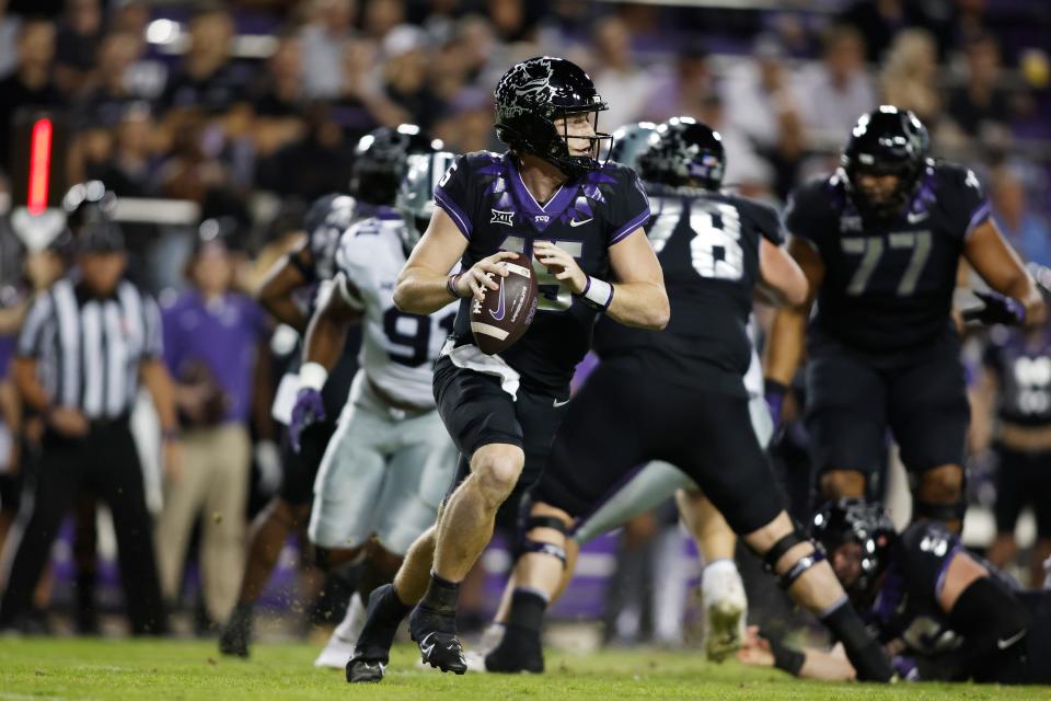 TCU quarterback Max Duggan (15) rolls out to pass against Kansas State in the first quarter at Amon G. Carter Stadium.