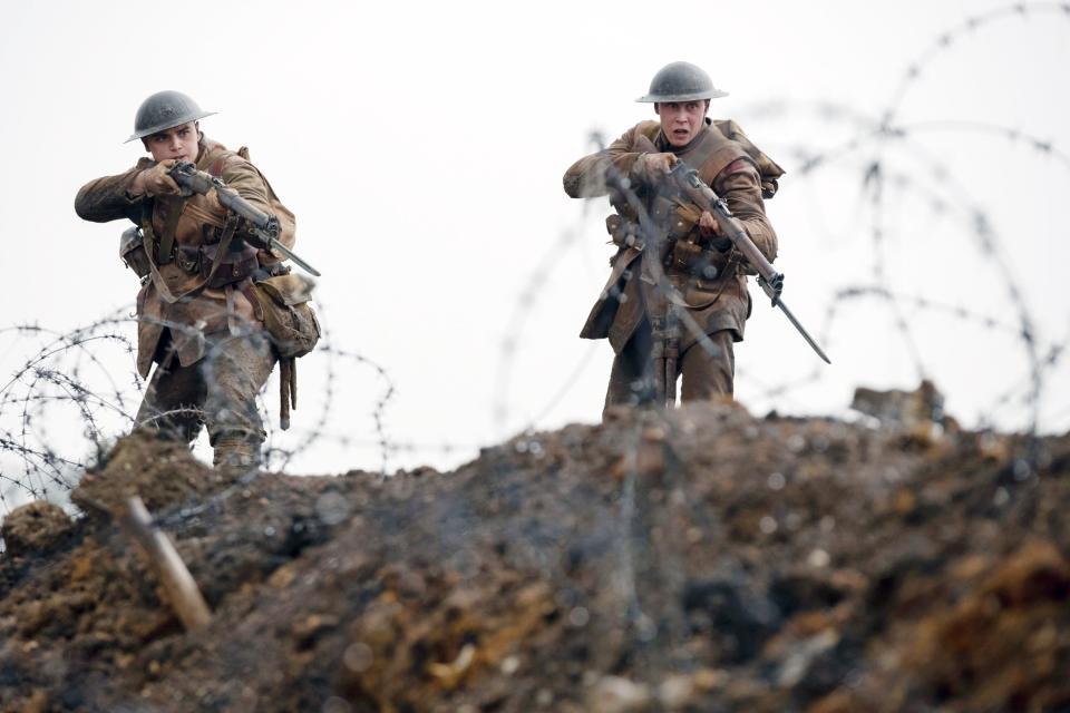 Dean-Charles Chapman and George MacKay cross barbed wire