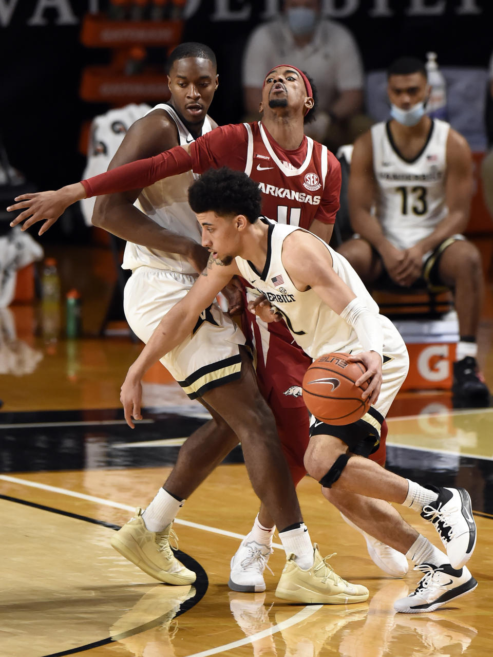 Vanderbilt guard Scotty Pippen Jr. (2) drives around Arkansas guard Jalen Tate (11) and as forward Clevon Brown, left, sets a pick during the second half of an NCAA college basketball game against Vanderbilt Saturday, Jan. 23, 2021, in Nashville, Tenn. Arkansas won 92-71. (AP Photo/Mark Zaleski)