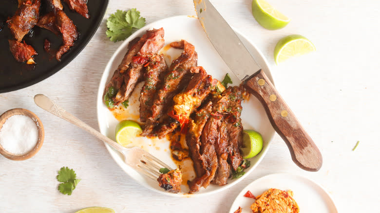 chipotle steak on a plate with fork and knife