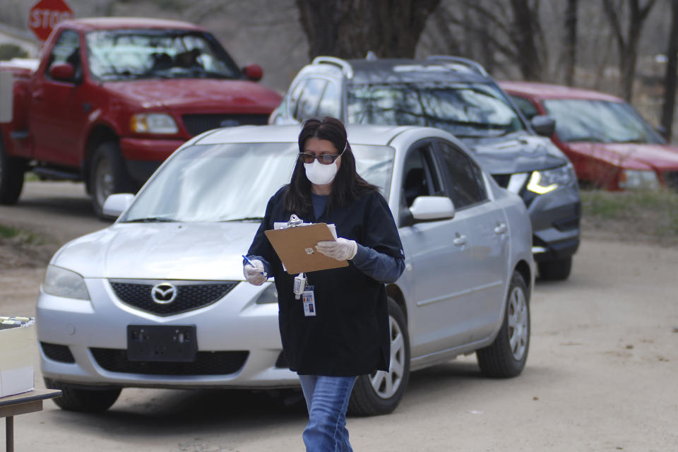 Cars line up for coronavirus testing at the Native American community of Picuris Pueblo, N.M., Thursday, April 23, 2020. Pueblo leaders including Gov. Craig Quanchello see COVID-19 as a potentially existential threat for the pueblo of just over 300 members and have implemented universal testing. (AP Photo/Morgan Lee)