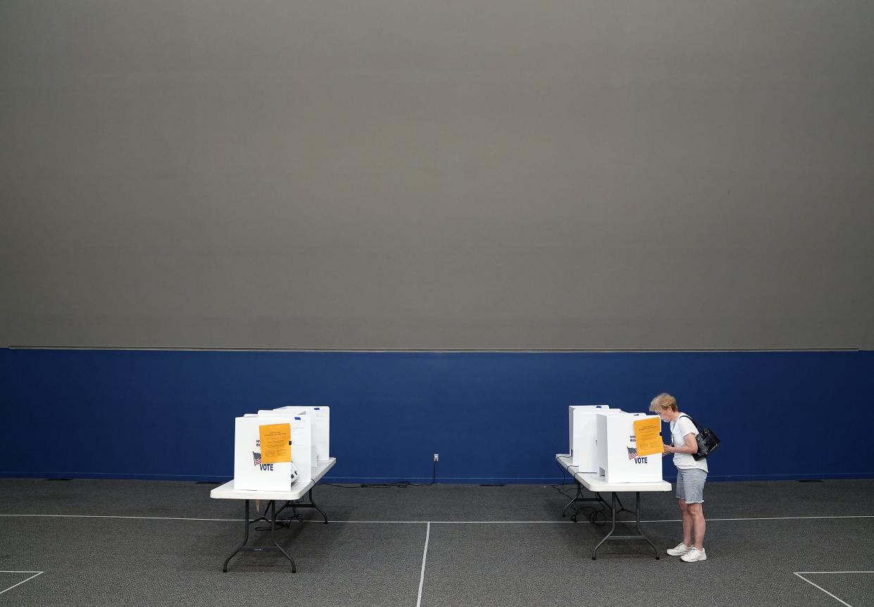 Roxanne Mackei of Columbus, right, votes during the Primary elections at United Methodist Church in Hilliard on August 2, 2022.