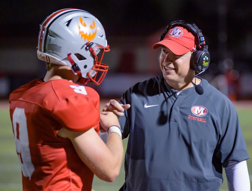 Morton head coach Adam O'Neill, right, congratulates running back Seandon Buffington late in the second half of their Week 4 football game Friday, Sept. 15, 2023 in Morton. The Potters downed the Metamora Redbirds 45-19.