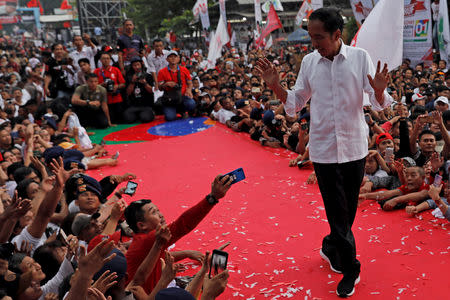 Indonesia's presidential candidate Joko Widodo gestures as he greets his supporters at a carnival during a campaign rally in Tangerang, Banten province, Indonesia, April 7, 2019. REUTERS/Willy Kurniawan/File Photo