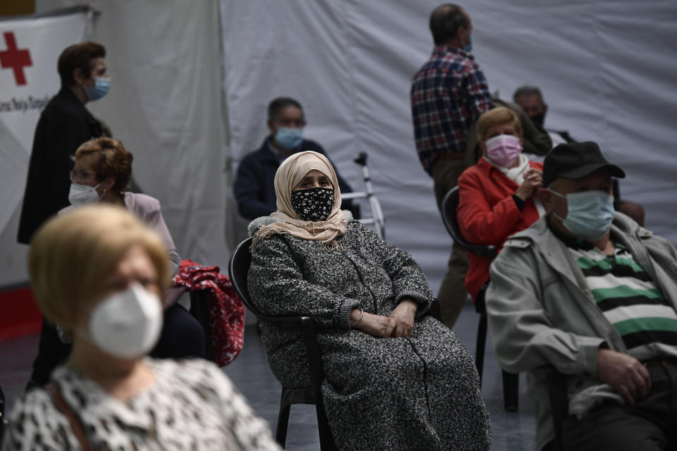 Taia Ilhachamia, center, waits 15 minutes after receiving the Pfizer vaccine during a COVID-19 vaccination campaign in Alfaro, northern Spain, Thursday, May 13, 2021. (AP Photo/Alvaro Barrientos)
