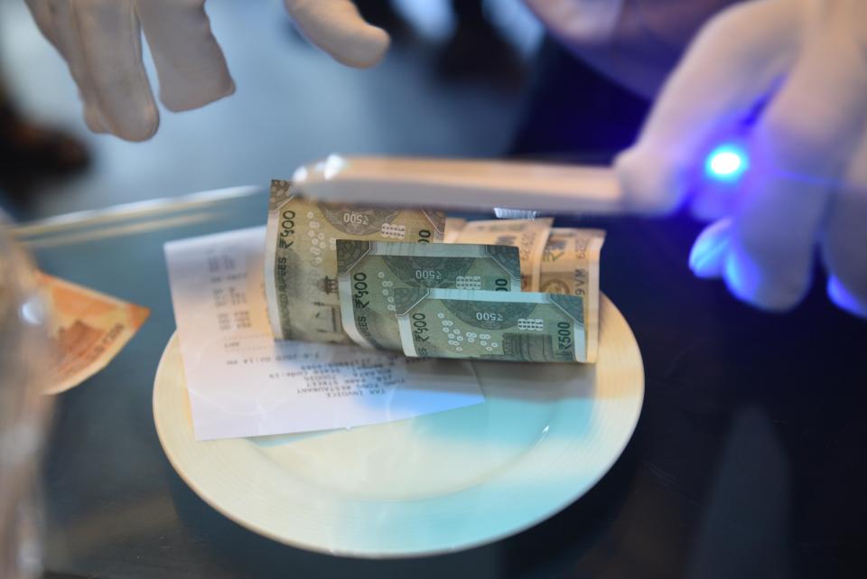 KOLKATA, INDIA - JUNE 8: Currency notes being disinfected under a UV light at Tung Fong Restaurant on Park Street, on June 8, 2020 in Kolkata, India. (Photo by Samir Jana/Hindustan Times via Getty Images)