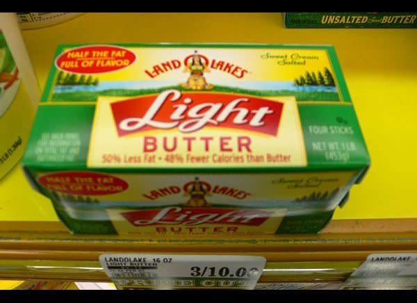 If you still prefer a stick over a tub, light or low-fat butter is a smart choice. It's made with added water or gelatin (and preservatives) to give it a solid consistency, and it generally has half the fat and calories as traditional butter.     A serving of Land O'Lakes Light Butter, for example, has only 50 calories and 6 grams of fat (3.5 grams saturated). Just don't use twice as much to make up for any difference in flavor, says Janice Baker, RD, a nutritionist and certified diabetes educator.  