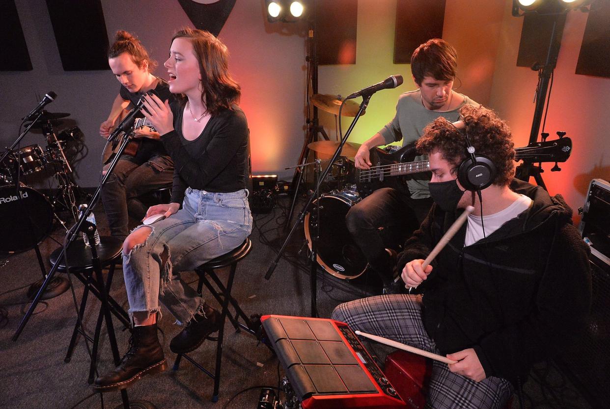 First To Eleven band members, from back left to right, guitarist Matthew Yost, vocalist Audra Miller, bassist Ryan Krysiak, and drummer Sam Gilman, perform during a livestream for fans on Facebook from the Rock School Studios. The band, currently touring the East Coast, is making a stop in Erie on Friday, Aug. 26.