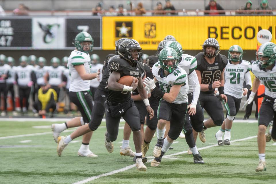 Lena-WInslow's Marey Roby runs past the Carrollton defense in the IHSA Class 1A football championship game on Friday, November 26, 2021 at Huskie Stadium in DeKalb.