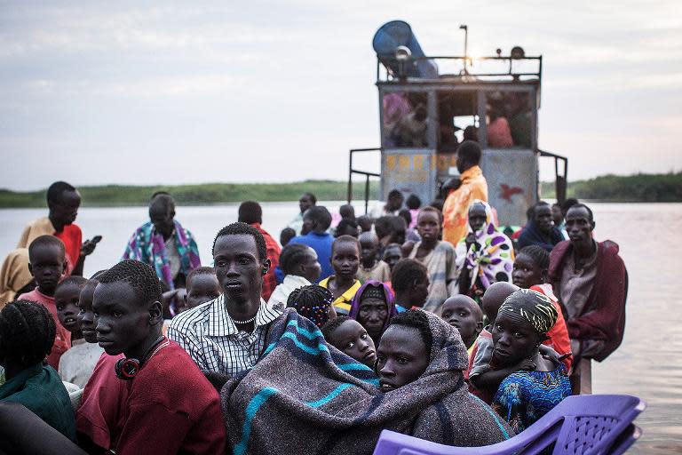 This picture taken on January 9, 2014 shows displaced people on a ferry in Minkammen, South Sudan