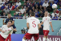 France's Kylian Mbappe, left top, scores his side's third goal during the World Cup round of 16 soccer match between France and Poland, at the Al Thumama Stadium in Doha, Qatar, Sunday, Dec. 4, 2022. (AP Photo/Ricardo Mazalan)