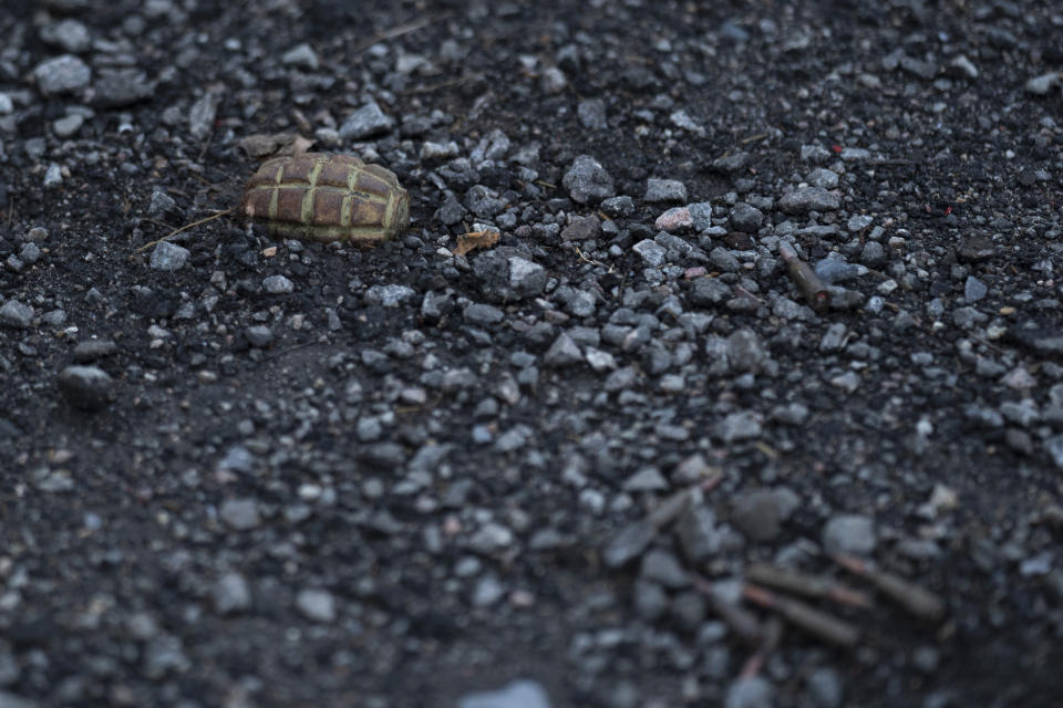 A hand grenade is seen on the road at the entrance of the freed village of Hrakove, Ukraine, Tuesday, Sept. 13, 2022. Russian troops occupied this small village southeast of Ukraine’s second largest city of Kharkiv for six months before suddenly abandoning it around Sept. 9 as Ukrainian forces advanced in a lightning-swift counteroffensive that swept southward. (AP Photo/Leo Correa)