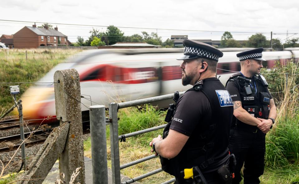 Police near the scene in Balderton, near Newark-on-Trent. A police officer is in a serious condition after being hit by a train while trying to save a distressed man who was on the tracks. Nottinghamshire Police said officers were deployed to a residential area in Balderton just before 7pm on Thursday, over concerns for a man's safety. Picture date: Friday August 25, 2023.