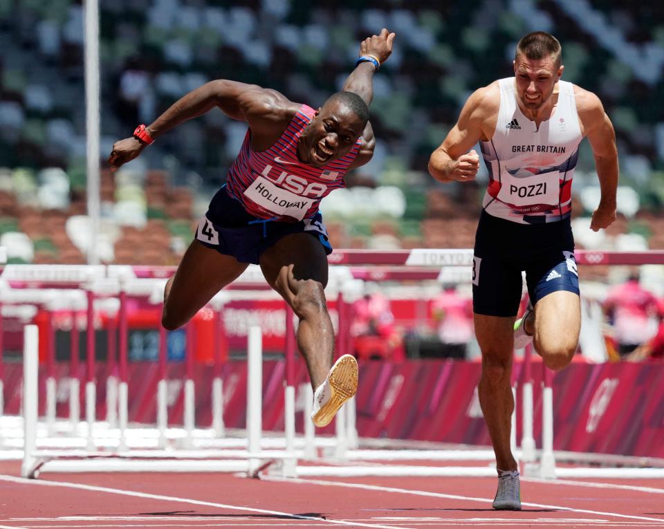 Grant Holloway reaches for the finish line in the 110-meter hurdles Thursday.