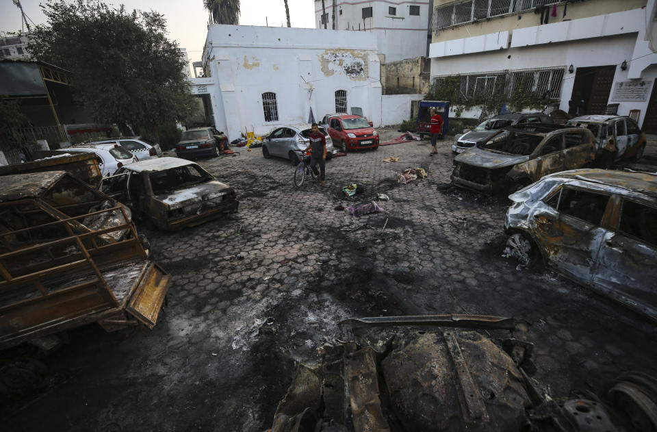 Palestinians check the area of the explosion at al-Ahli Hospital in Gaza City, Wednesday, Oct. 18, 2023. (AP Photo/Abed Khaled)