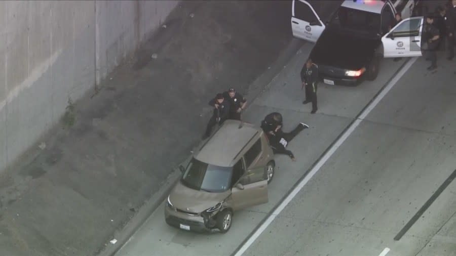 LAPD officers arrest the suspect of the allegedly stolen vehicle on the 110 Freeway after a lengthy pursuit on April 19, 2024. (KTLA)