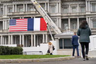 American and French flags are in place on the Old Executive Office Building on the White House campus Tuesday, Nov. 29, 2022, in Washington, in advance of the State Visit by French President Emmanuel Macron. (AP Photo/Andrew Harnik)